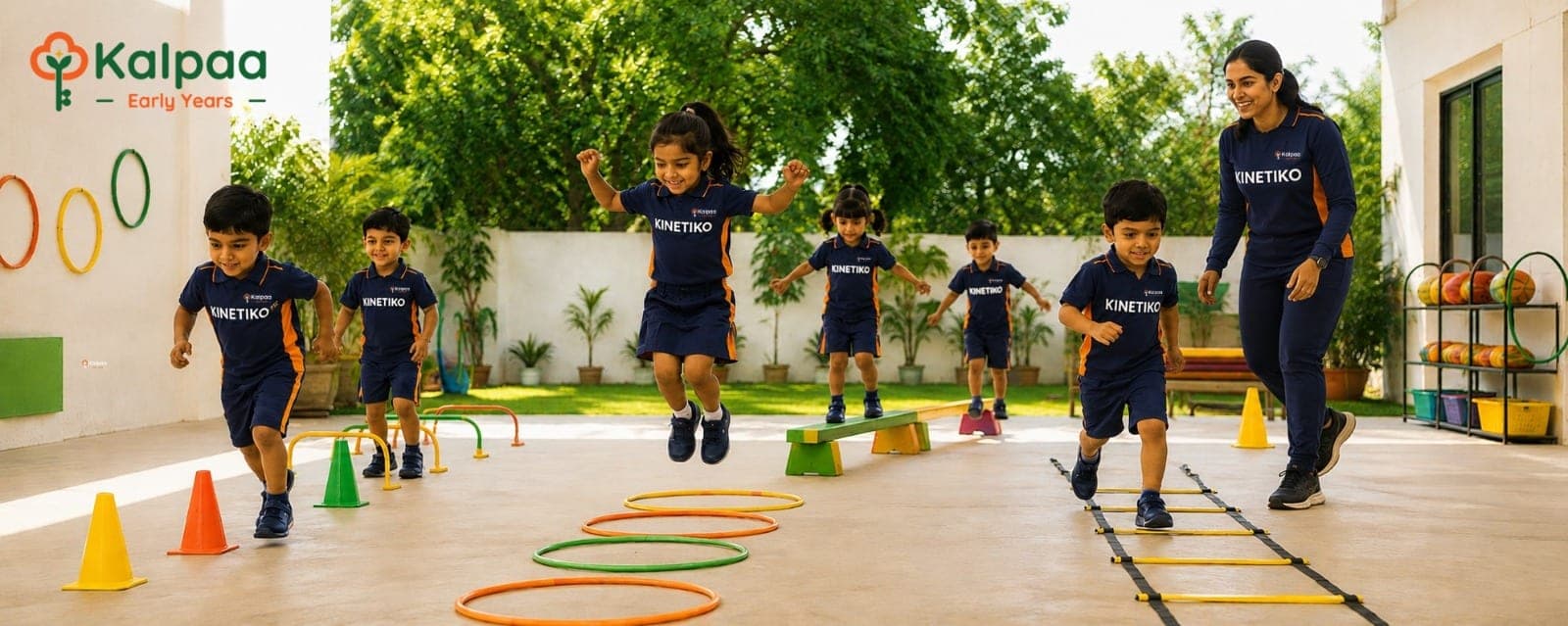 Kalpaa children in Kinetiko kit jumping through hoops and ladders on the outdoor course